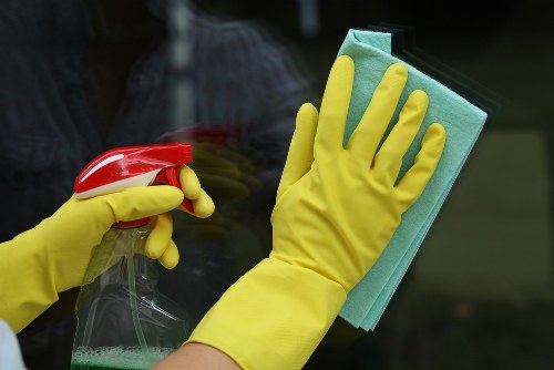 Cleaner deep cleaning a kitchen during an end of tenancy service