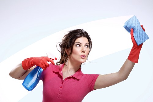 Cleaning staff using safe chemical handling practices in a bathroom
